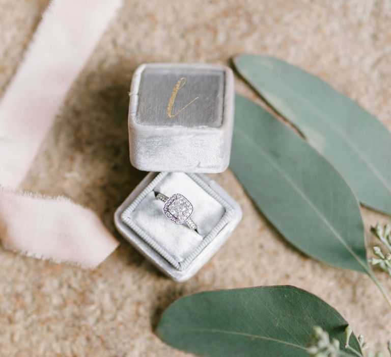 Close up off wedding ring in grey velvet box with eucalyptus leaves Fine Art Wedding Photographers