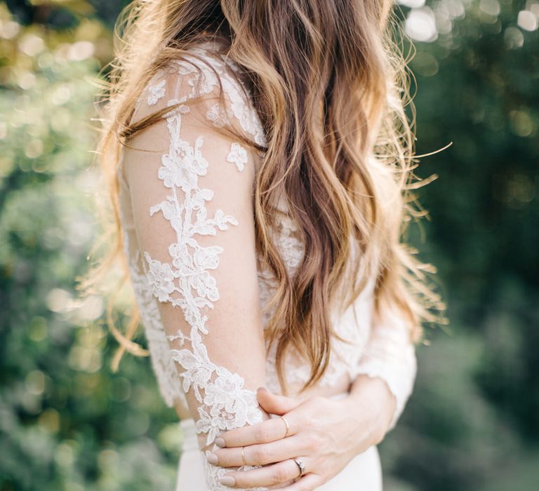 Close up of bride touching lace wedding dress sleeve - Fine Art Wedding Photographer