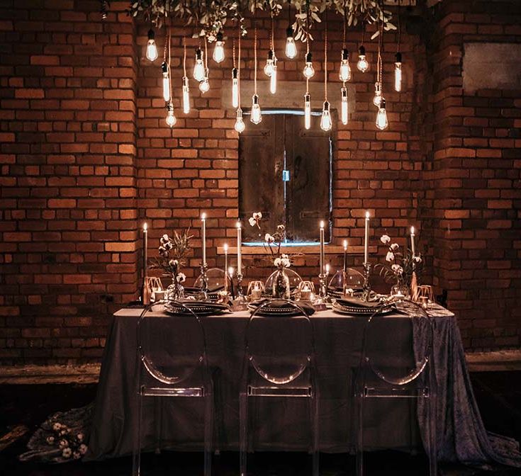 Candle Light Table Scape with Ghost Chairs & Glass Platters | Edison Lights | Industrial Wedding Inspiration at Victoria Warehouse in Manchester | Planning & Styling by The Urban Wedding Company | 2 Ducks Galleries