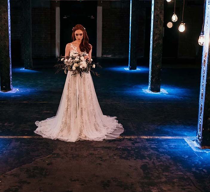 Bride in Lace Gown from Frock & Soul | White Rose & Cotton Bud Bouquet | Edison Lights | Industrial Wedding Inspiration at Victoria Warehouse in Manchester | Planning & Styling by The Urban Wedding Company | 2 Ducks Galleries