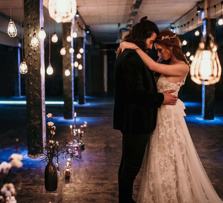 Bride in Lace Gown from Frock & Soul | White Rose & Cotton Bud Bouquet | Edison Lights | Industrial Wedding Inspiration at Victoria Warehouse in Manchester | Planning & Styling by The Urban Wedding Company | 2 Ducks Galleries