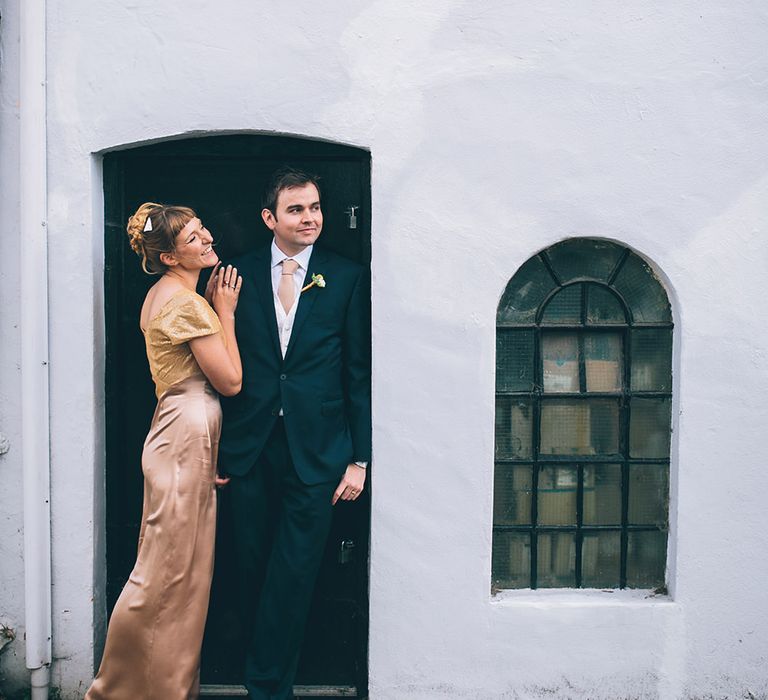 Bride in Bespoke Gold Gown & Groom in Moss Bros Hire Suit