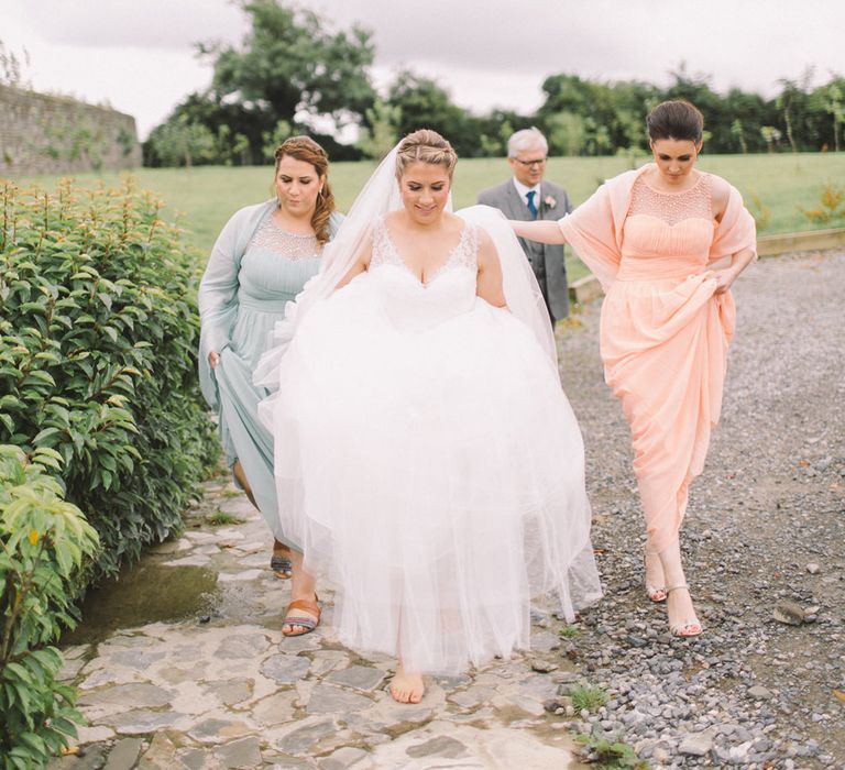 Bride in Modeca Wedding Dress & Bridesmaids in Pastel Peach & Green Gowns