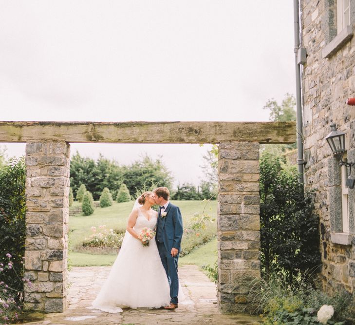 Bride in Modeca Wedding Dress & Groom in Navy Three Piece Suit