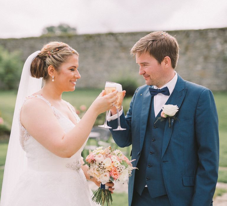 Bride in Modeca Wedding Dress & Groom in Navy Three Piece Suit