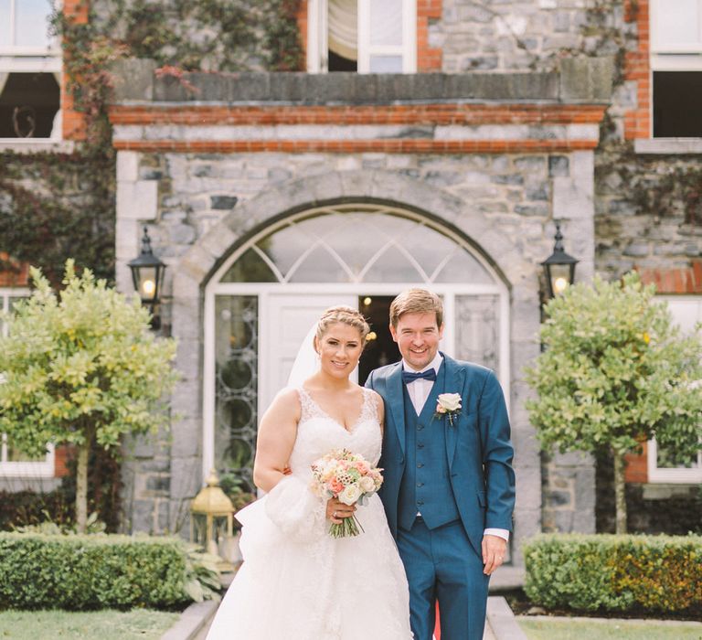 Bride in Modeca Wedding Dress & Groom in Navy Three Piece Suit