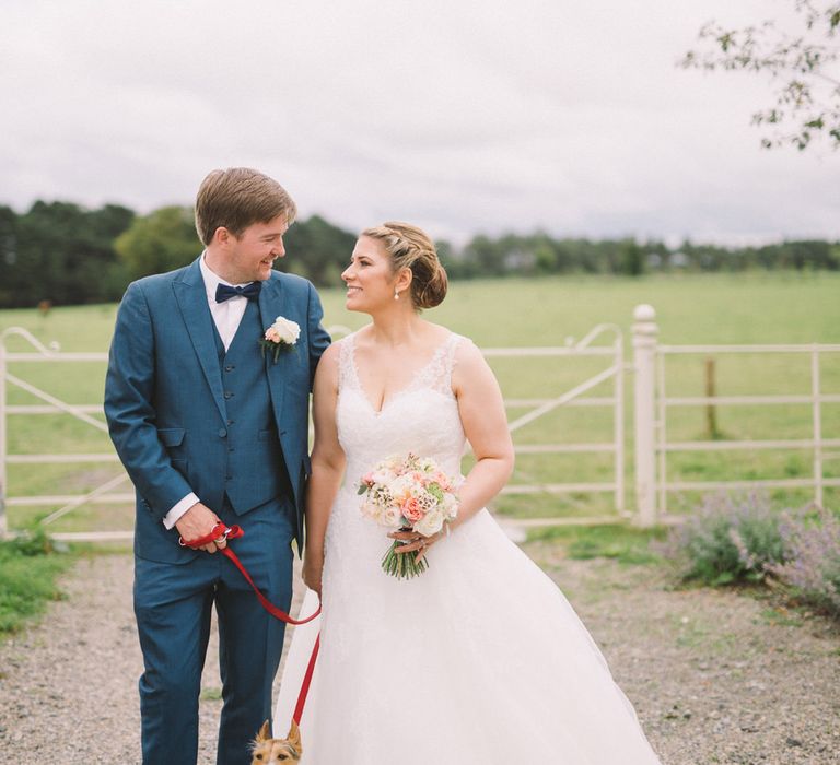 Bride in Modeca Wedding Dress & Groom in Navy Three Piece Suit