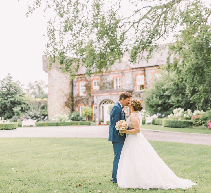 Bride in Modeca Wedding Dress & Groom in Navy Three Piece Suit