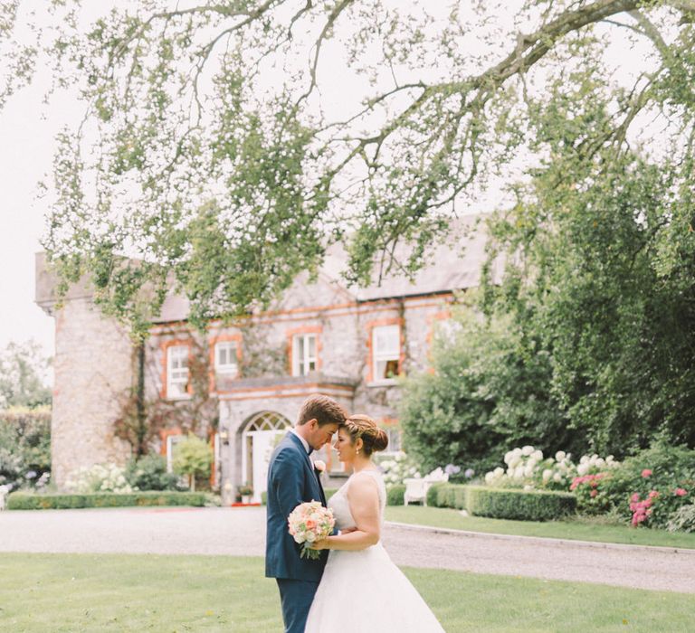 Bride in Modeca Wedding Dress & Groom in Navy Three Piece Suit