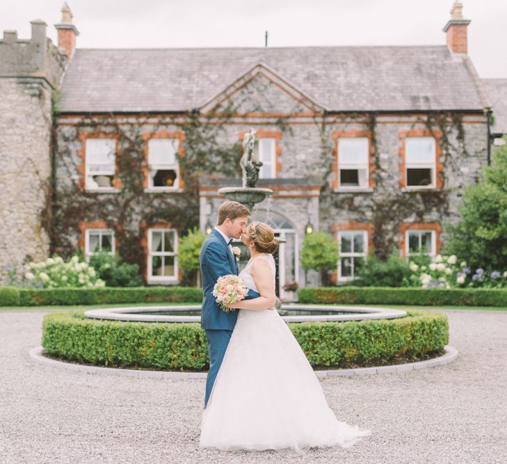 Bride in Modeca Wedding Dress & Groom in Navy Three Piece Suit