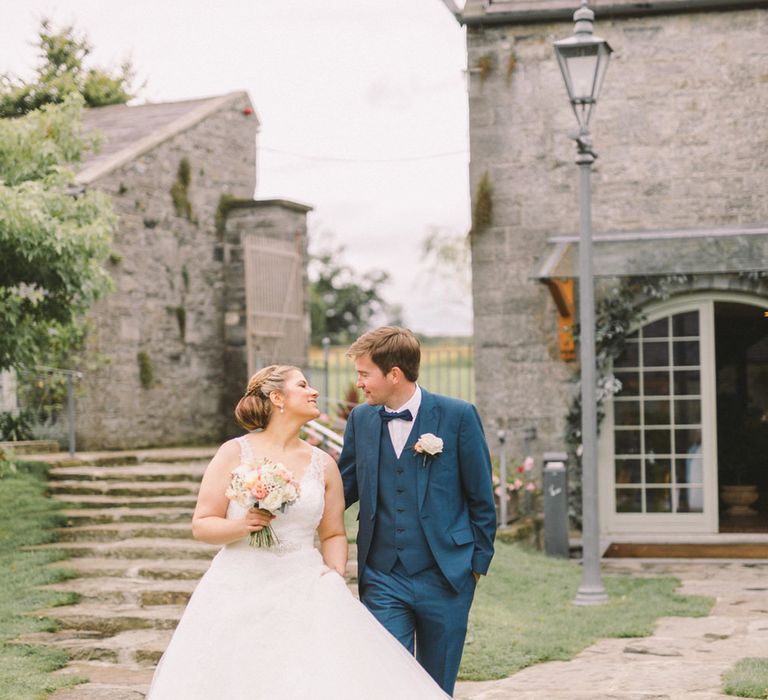 Bride in Modeca Wedding Dress & Groom in Navy Three Piece Suit