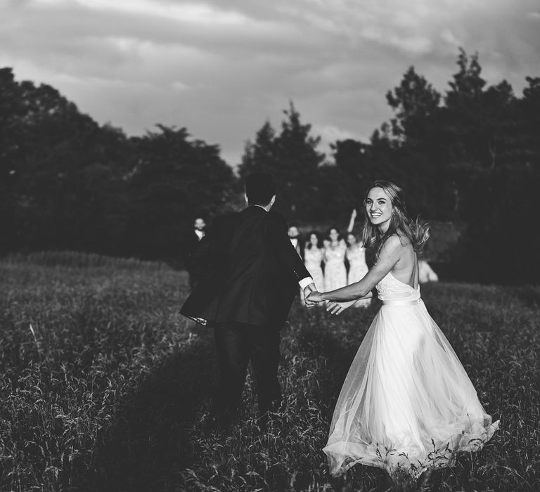 Bride in Catherine Deane Carly Bridal Gown | Groom in Navy Suit | Bright At Home Tipi Wedding | Barney Walters Photography