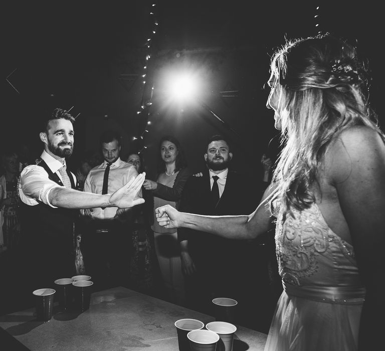 Beer Pong | Bride in Catherine Deane Carly Bridal Gown | Groom in Navy Suit | Bright At Home Tipi Wedding | Barney Walters Photography