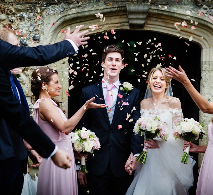 Confetti Exit | Bride in Sassi Holford Grace Wedding Dress | Groom in Traditional Oliver Brown Tailored Suit | Blink Photography