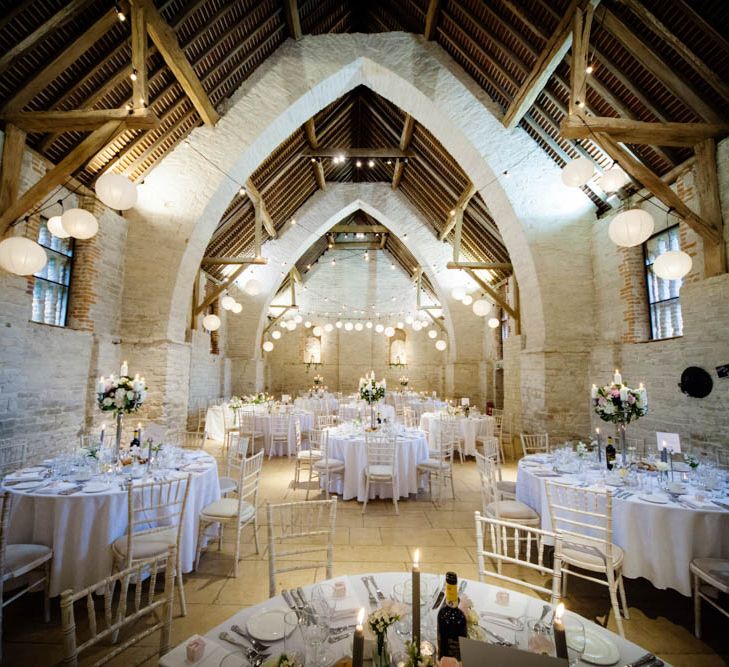 Hanging Lanterns and Floral Candelabra Centrepiece | Classic Pink Wedding at The Tithe Barn in Hampshire | Blink Photography