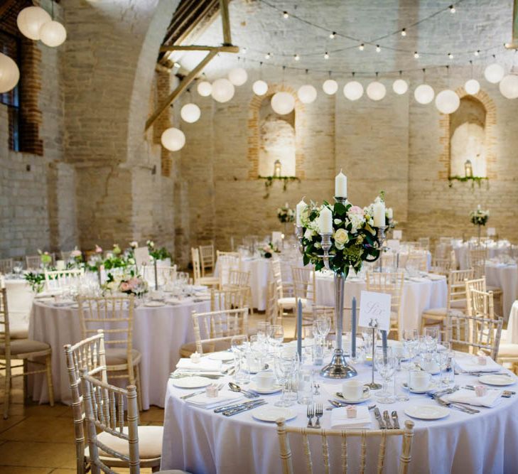 Hanging Lanterns and Floral Candelabra Centrepiece | Classic Pink Wedding at The Tithe Barn in Hampshire | Blink Photography