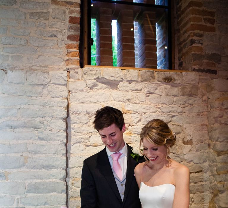 Cutting the Cake | Bride in Sassi Holford Grace Wedding Dress | Groom in Traditional Oliver Brown Tailored Suit | Blink Photography