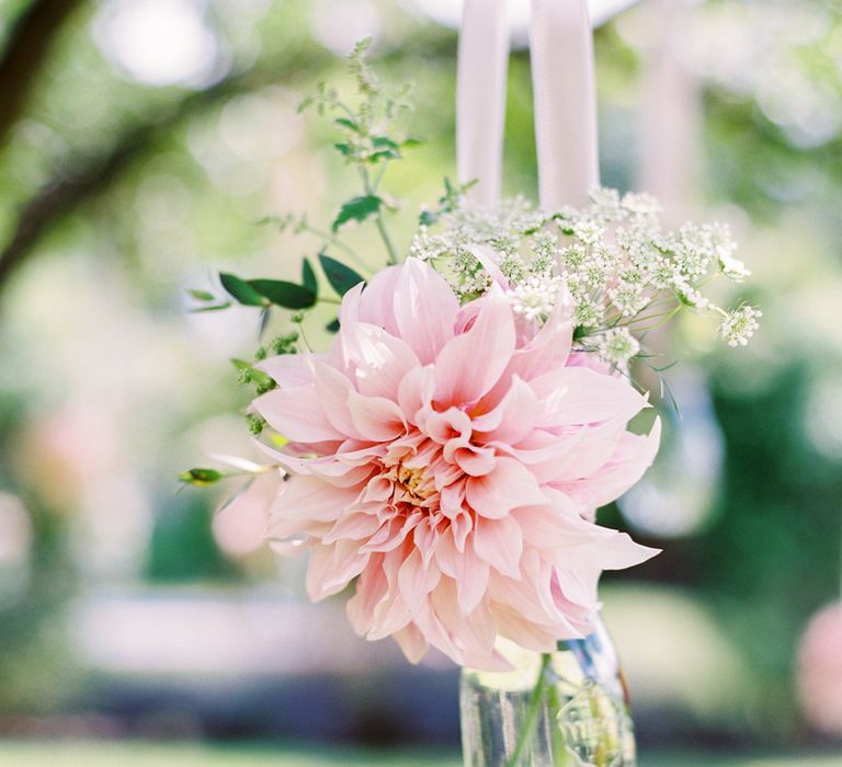 Dahlias in jam jars hanging from trees