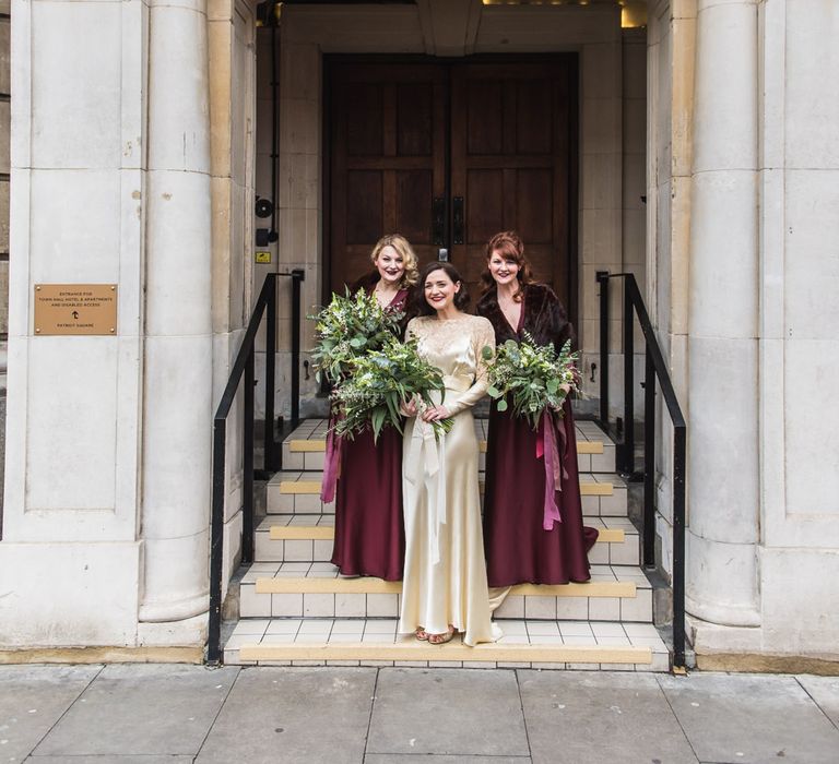 Bridesmaids in Burgundy BHLDN Dresses | Bride in Story of My Dress Bridal Gown | Greenery Bouquet | Vintage Wedding at The Asylum & Town hall Hotel London | Kevin Fern Photography