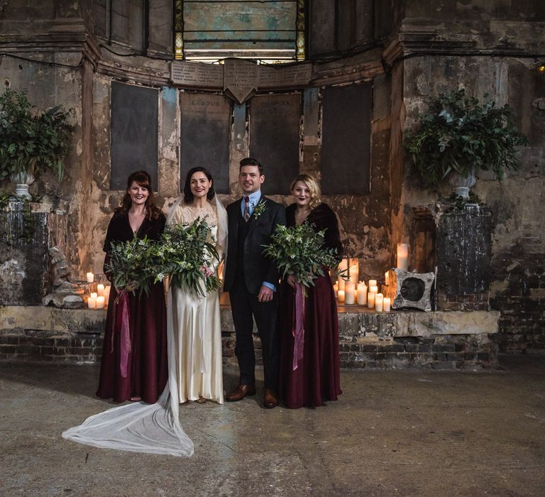 Bridesmaids in Burgundy BHLDN Gowns | Bride in Story of My Dress Bridal Gown | Groom in Navy Suit from Tom James Tailors | Vintage Wedding at The Asylum & Town hall Hotel London | Kevin Fern Photography