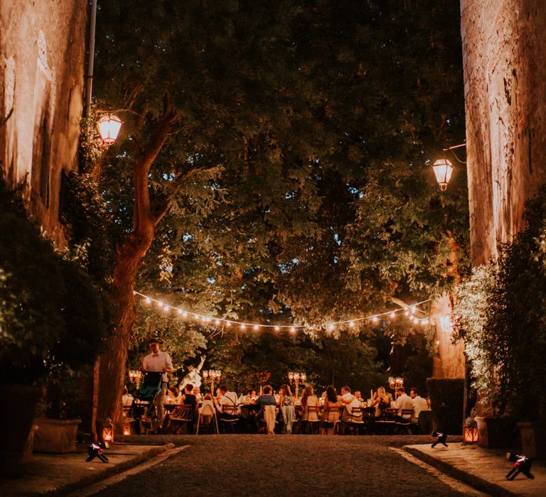 Festoon Lit Outdoor Reception | Bride in Morgan Davies Gown | Groom in Suit Supply | D&A Photography | Ben Walton Films