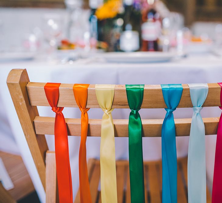 Rainbow Ribbon Details On Chairs For Wedding // Outdoor Summer Wedding With Bright Colour Scheme With Colourful Homemade Decor And Images From Story + Colour Photography