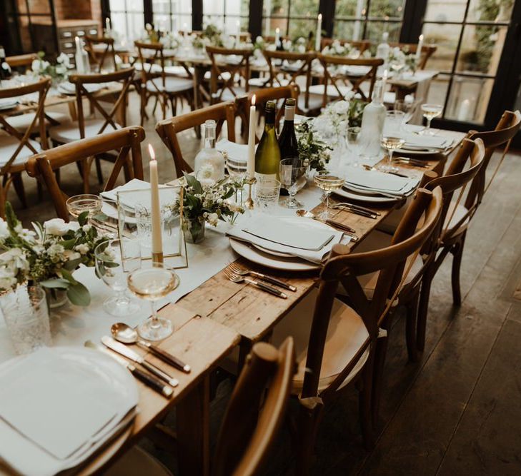 Wooden Trestle Tables With Soft Grey Runners, Taper Candles And White Florals For Wedding Image By The Curries