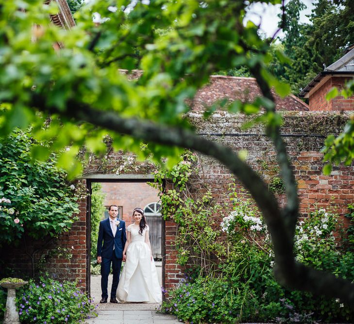 Bride in Aire Barcelona Bridal Gown & Groom in Ted Baker Suit