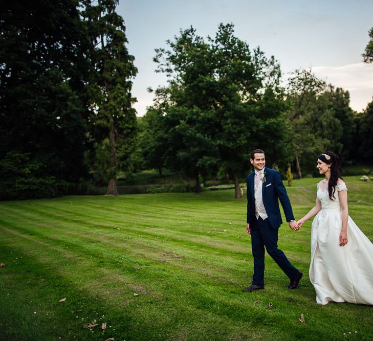 Bride in Aire Barcelona Bridal Gown & Groom in Ted Baker Suit