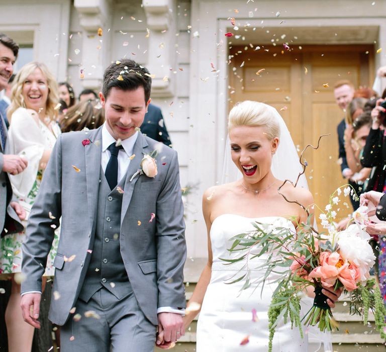 Confetti Exit | Bride in Anna Serrano Gown | Groom in Grey Suit | Stylish Hackney Town Hall Wedding | Camilla Arnhold Photography | This Modern Revelry Film