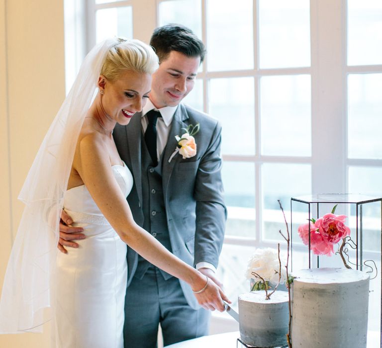 Cutting The Cake | Bride in Anna Sorrano Gown | Groom in Grey Suit | Stylish Hackney Town Hall Wedding | Camilla Arnhold Photography | This Modern Revelry Film