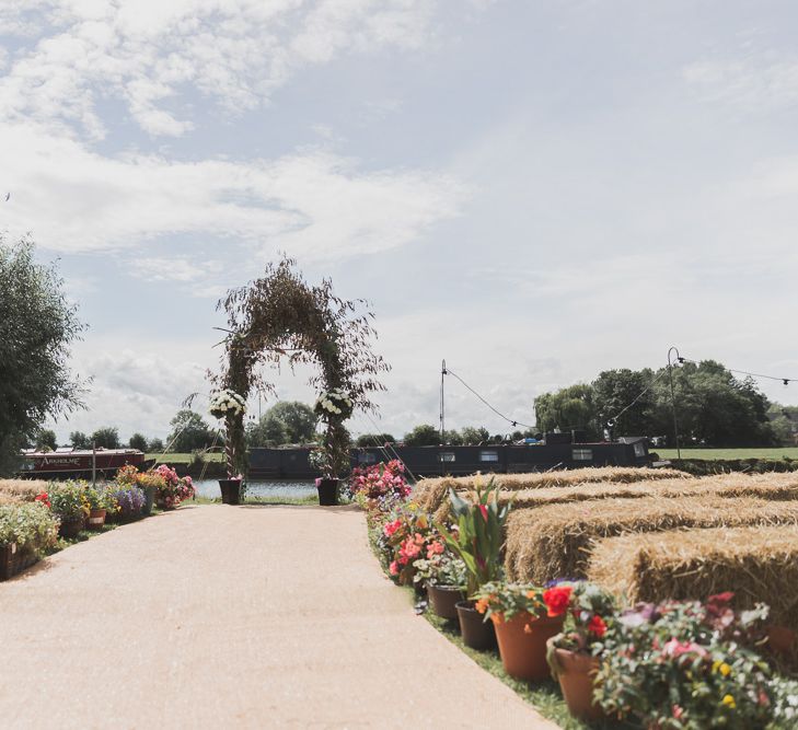 Outdoor Wedding Ceremony With Haybale Seating & Chalkboard Sign