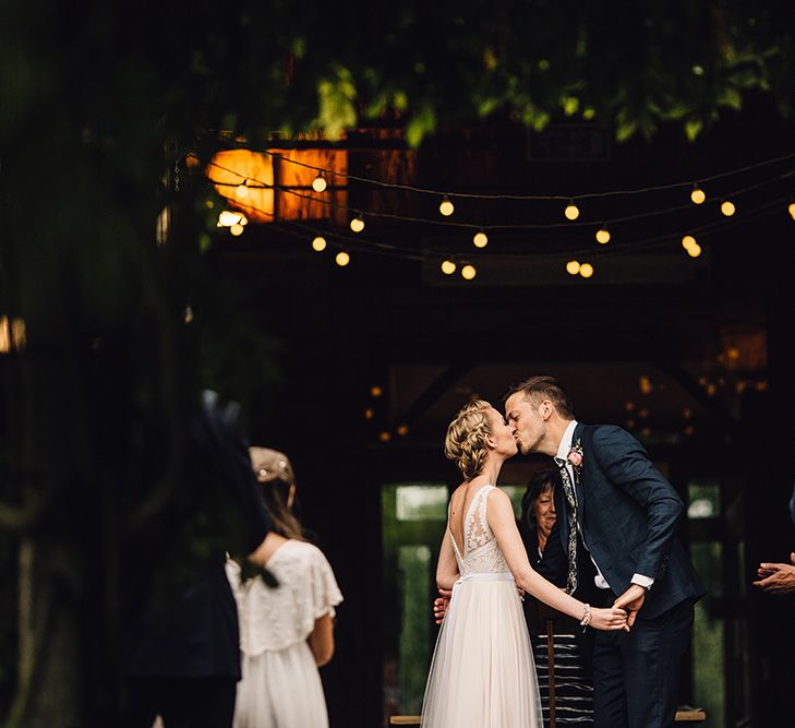 Bride in Catherine Deane Tamsin Wedding Dress & Groom in Paul Smith Suit