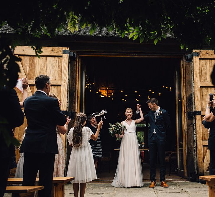 Bride in Catherine Deane Tamsin Wedding Dress & Groom in Paul Smith Suit