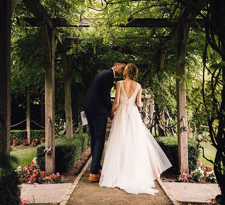 Bride in Catherine Deane Tamsin Wedding Dress & Groom in Paul Smith Suit