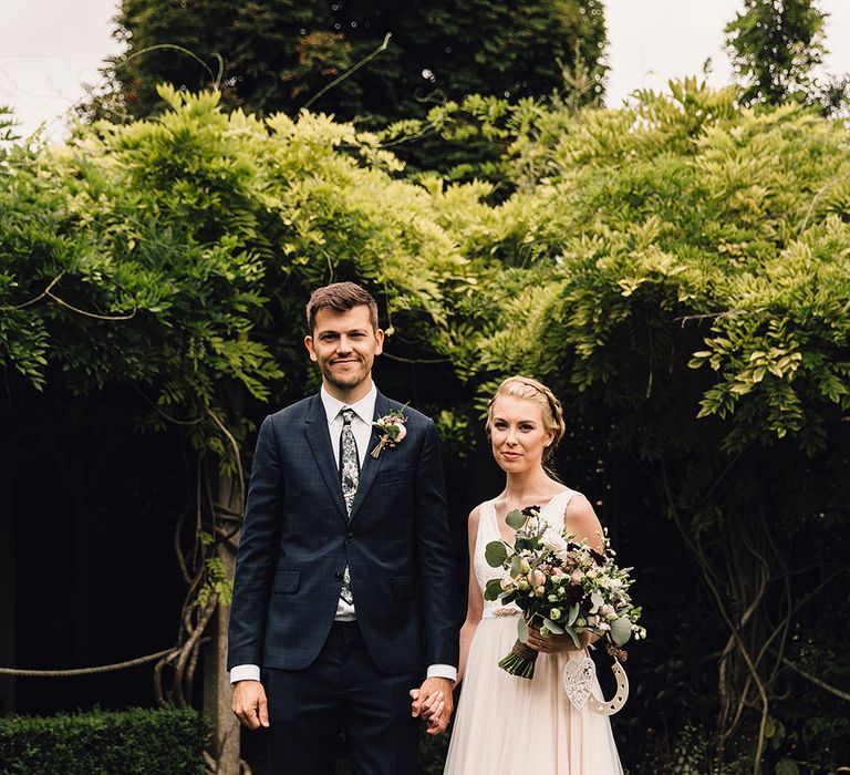 Bride in Catherine Deane Tamsin Wedding Dress & Groom in Paul Smith Suit