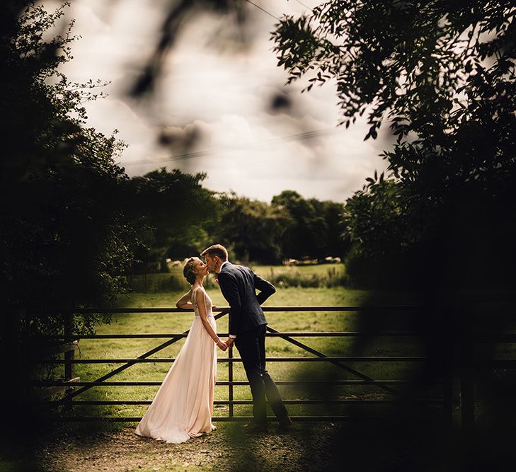 Bride in Catherine Deane Tamsin Wedding Dress & Groom in Paul Smith Suit