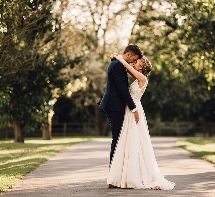 Bride in Catherine Deane Tamsin Wedding Dress & Groom in Paul Smith Suit