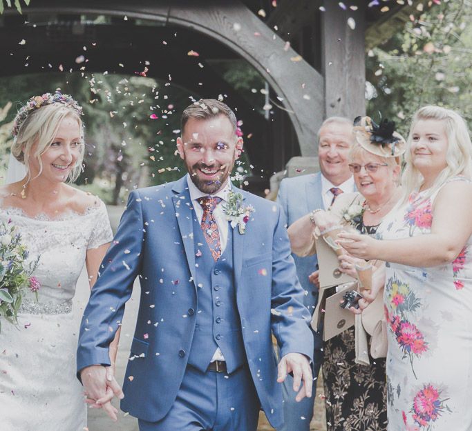 Confetti Moment with Bride in Lace Sincerity Bridal Wedding Dress & Groom in Blue Ted Baker Suit