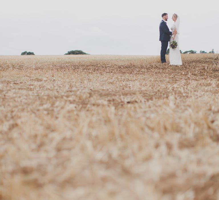 Bride in Lace Sincerity Bridal Wedding Dress & Groom in navy Ted Baker Suit