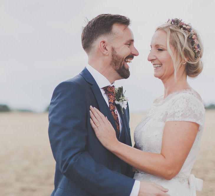 Bride in Lace Sincerity Bridal Wedding Dress & Groom in navy Ted Baker Suit