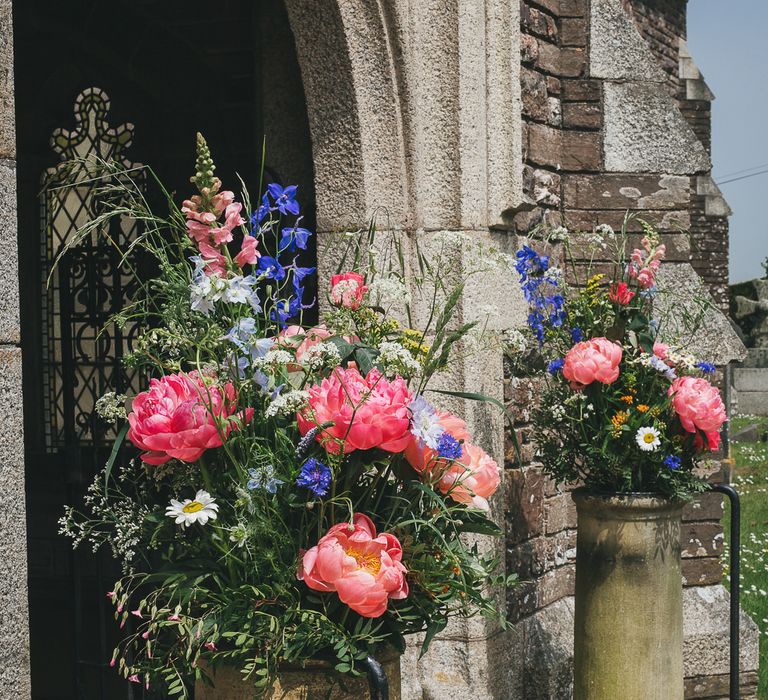 Milk Churns Full of Brightly Coloured Wild Flowers