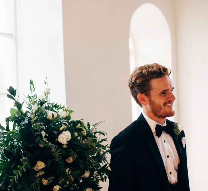 Groom waiting at the Altar