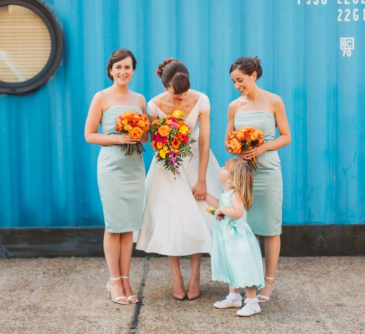 Bridesmaids in Teal With Orange Bouquets