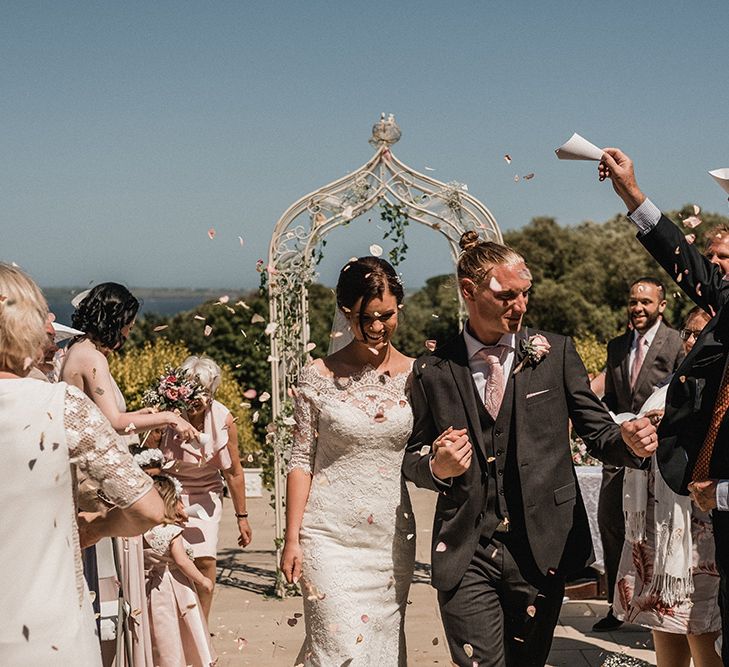 Confetti Moment | Bride in Pronovias Princia Lace Gown & Jacket | Outdoor Wedding at The Haven Hotel in Southern Ireland | Jason Mark Harris Photography