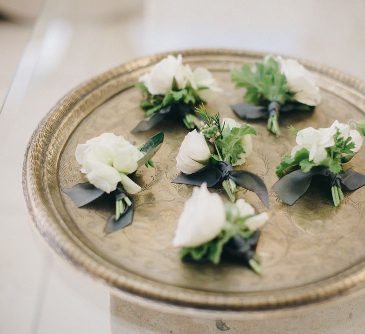 Buttonholes on Gold Platter | M and J Photography