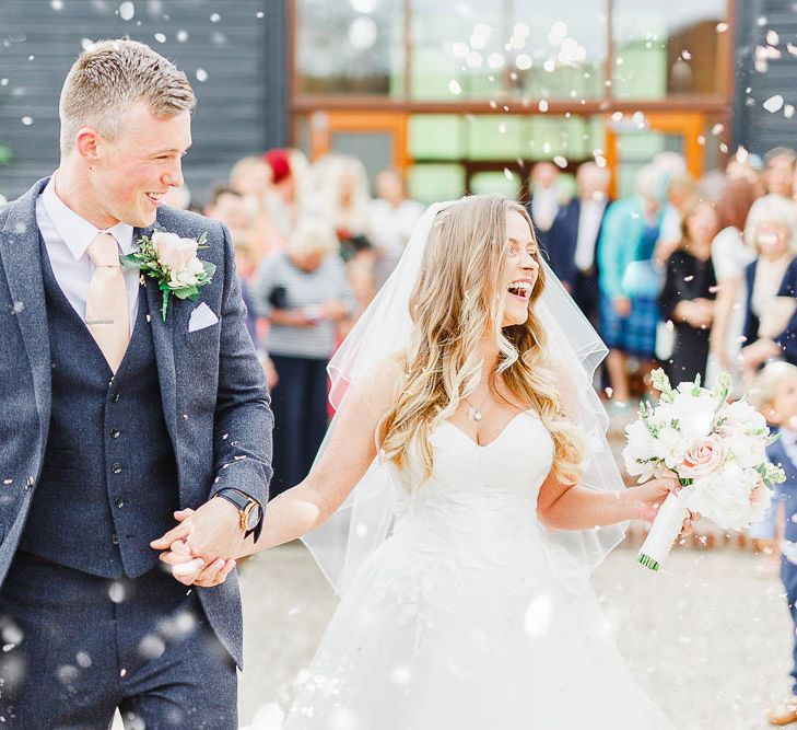 Confetti Moment | Bride in Warren Watters Gown | Groom in Marks and Spencer Suit | Peach & White Wedding at Upwaltham Barns | White Stag Wedding Photography