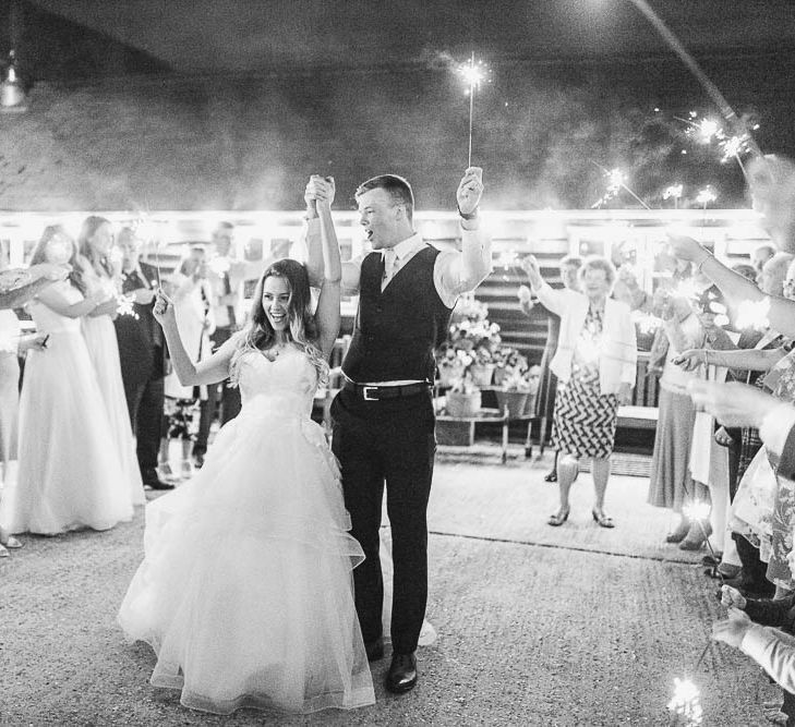 Sparkler Exit | Bride in Warren Watters Gown | Groom in Marks and Spencer Suit | Peach & White Wedding at Upwaltham Barns | White Stag Wedding Photography