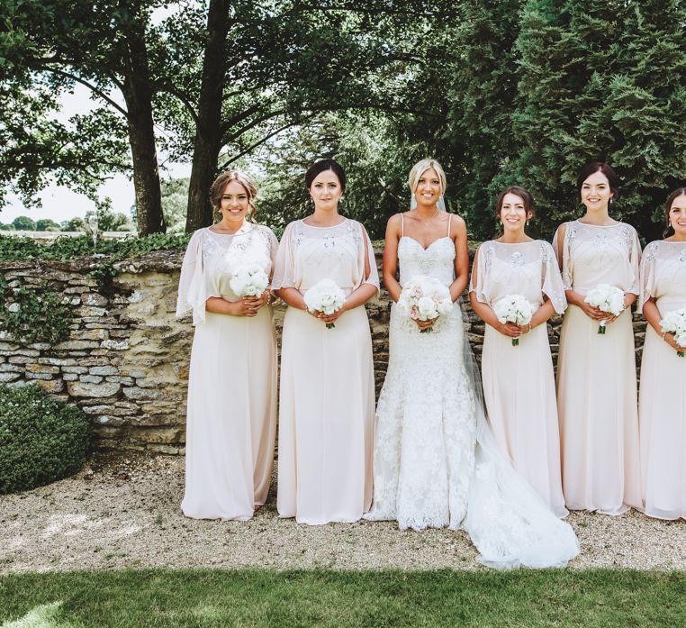 Wedding Party With Bridesmaids In Pale Sequinned Floor Length Dresses