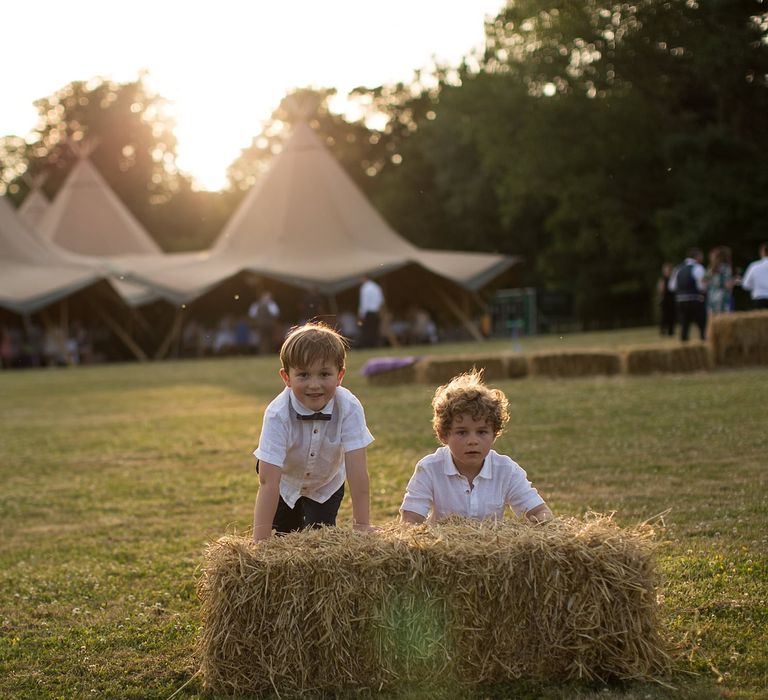 Page Boys at Outdoor Tipi Wedding with Hay Bale Seating